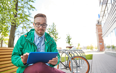 Image showing happy young hipster man with tablet pc and bike