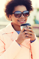 Image showing smiling african american woman drinking coffee