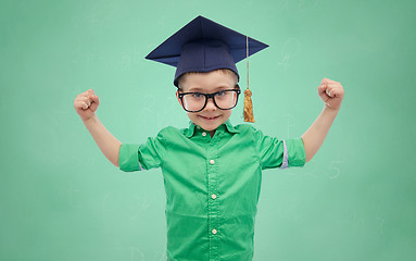 Image showing happy boy in bachelor hat showing power