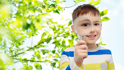 Image showing happy little boy looking through magnifying glass