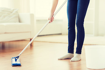 Image showing close up of woman with mop cleaning floor at home