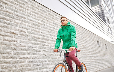 Image showing young hipster man riding fixed gear bike