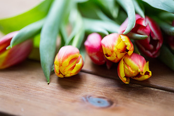 Image showing close up of tulip flowers on wooden table