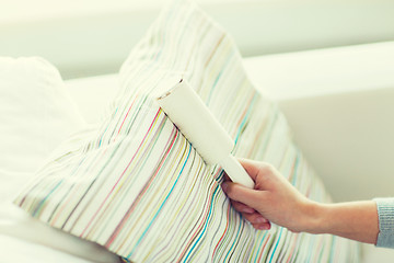 Image showing close up of woman hand with sticky roller cleaning