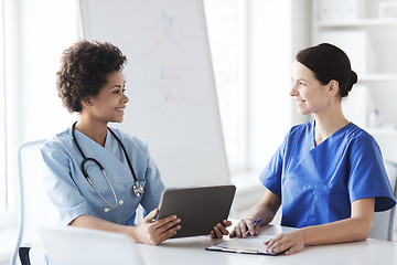 Image showing happy doctors with tablet pc meeting at hospital