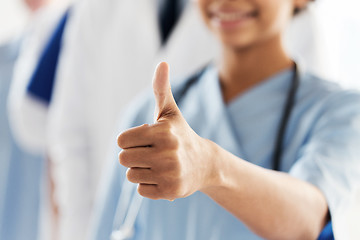 Image showing close up of doctor or nurse showing thumbs 