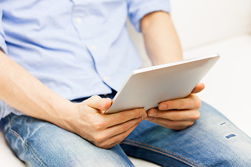 Image showing close up of man working with tablet pc at home