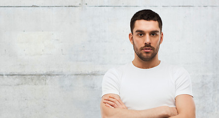 Image showing young man with crossed arms over gray background