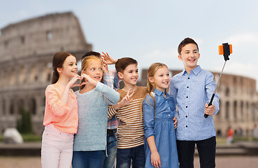 Image showing kids with smartphone selfie stick over coliseum