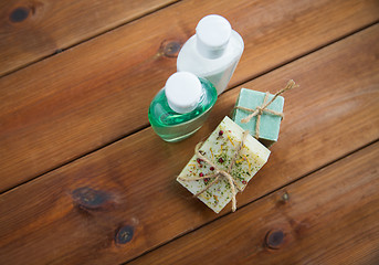 Image showing close up of handmade soap bars and lotions on wood