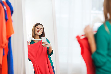 Image showing woman with smartphone taking mirror selfie at home