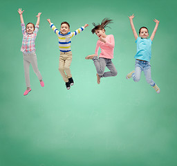 Image showing happy little girl jumping in air over school board