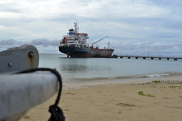 Image showing oil tanker vessel at dock with boat bow in foreground  anchor pu