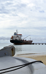 Image showing oil tanker vessel at dock with boat bow in foreground  anchor pu