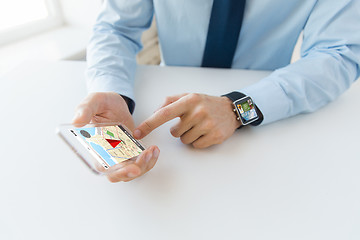 Image showing close up of hands with smart phone and watch