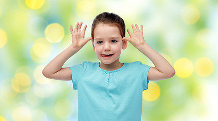 Image showing happy little girl having fun and making ears