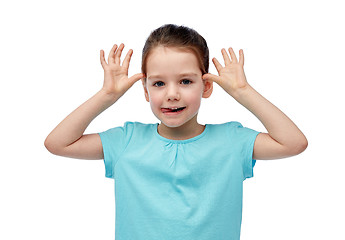 Image showing happy little girl having fun and making ears