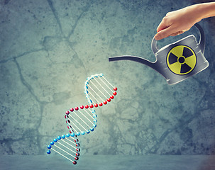 Image showing close up of hand with watering can and dna