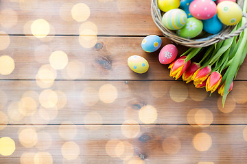 Image showing close up of easter eggs in basket and flowers