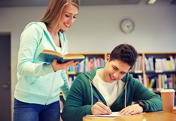 Image showing happy students preparing to exams in library