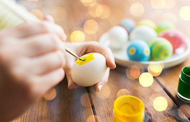 Image showing close up of woman hands coloring easter eggs