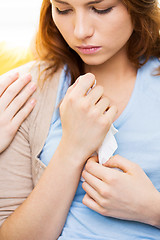 Image showing close up of crying teenage girl and friend hand