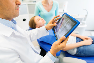 Image showing dentist with x-ray on tablet pc with patient girl