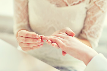 Image showing close up of lesbian couple hands with wedding ring