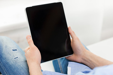 Image showing close up of man working with tablet pc at home