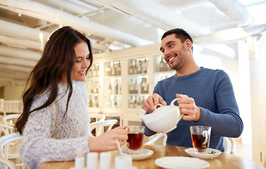 Image showing happy couple drinking tea at cafe