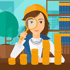 Image showing Woman with magnifier and golden coins. 