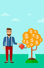 Image showing Man watering money tree.