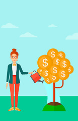 Image showing Woman watering money tree.