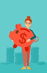 Image showing Woman carrying piggy bank.