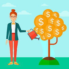 Image showing Woman watering money tree.