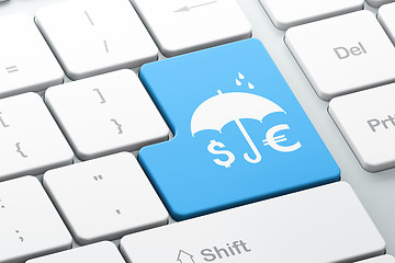 Image showing Protection concept: Money And Umbrella on computer keyboard background