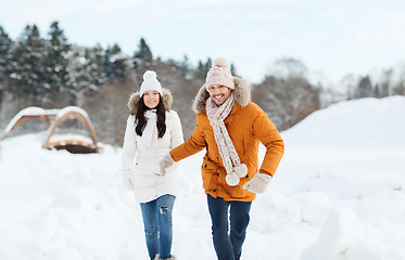 Image showing happy couple running over winter background