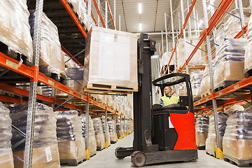 Image showing man on forklift loading cargo at warehouse