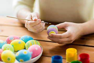 Image showing close up of woman hands coloring easter eggs