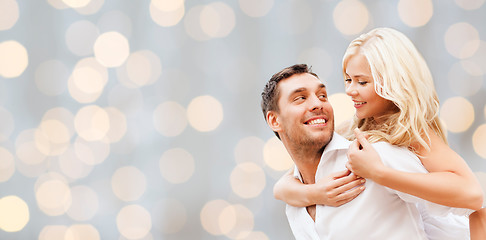 Image showing happy couple over holidays lights background