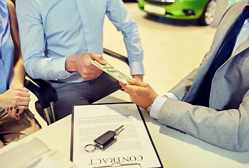 Image showing customers giving money to car dealer in auto salon