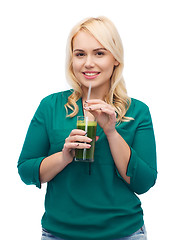 Image showing smiling woman drinking vegetable juice or smoothie