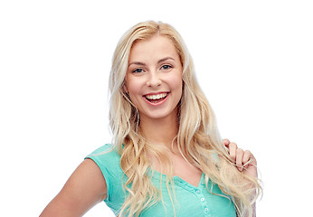 Image showing smiling young woman holding her strand of hair