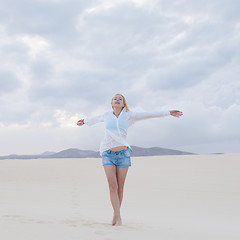 Image showing Carefree woman enjoying freedom on beach.