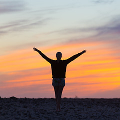 Image showing Woman enjoying freedom at sunset.