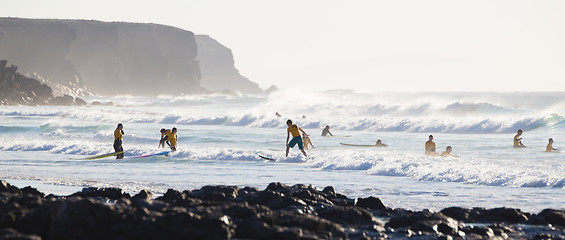 Image showing Surfers surfing on El Cotillo beach, Fuerteventura, Canary Islands, Spain.