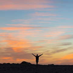 Image showing Woman enjoying freedom at sunset.