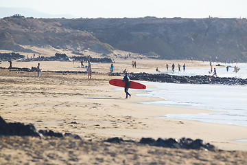 Image showing Surfers surfing on El Cotillo beach, Fuerteventura, Canary Islands, Spain.