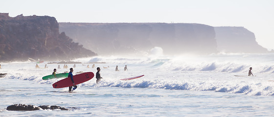 Image showing Surfers surfing on El Cotillo beach, Fuerteventura, Canary Islands, Spain.