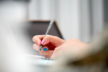 Image showing female hands with pen writing on notebook